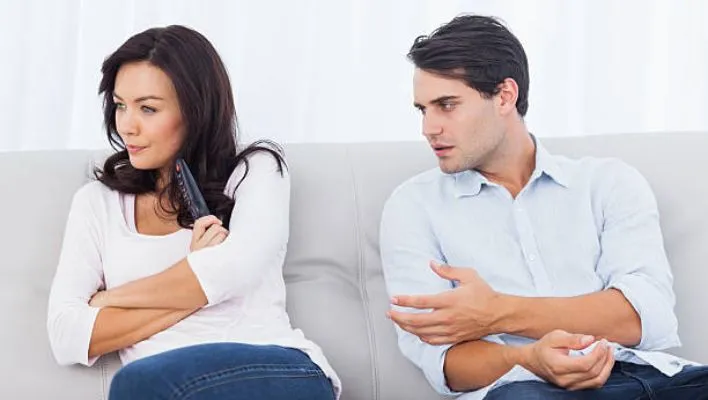 Couple arguing on couch showing control issues in a relationship